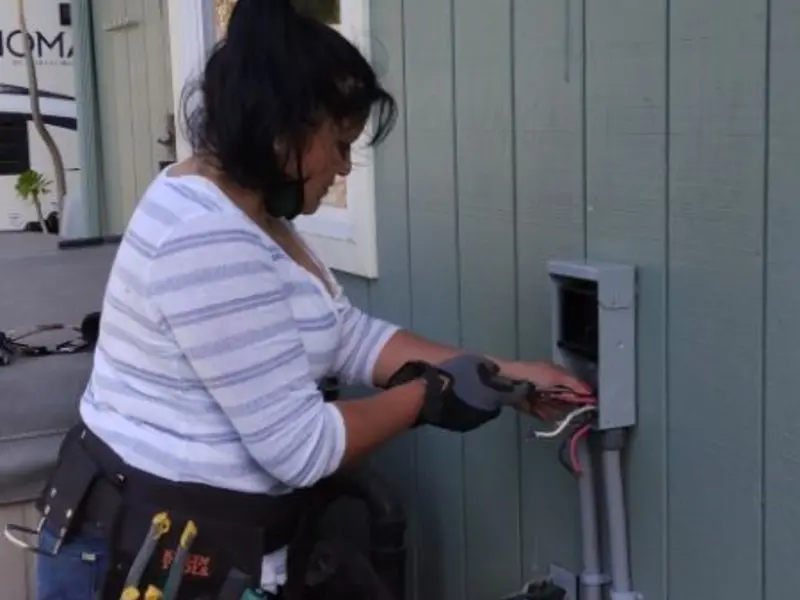 Licensed electrician wiring an exterior subpanel in Margate